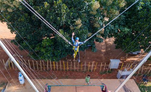 a man on a zip line on a trampoline at Quad Club - Resort and Spa, Nandi Hills in Nandigunda