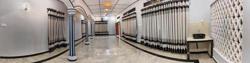 a hallway with a row of stalls in a building at Gunam guest house in Point Pedro