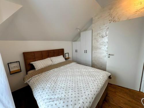 a bedroom with a large bed and a white cabinet at Silver Hills in Zlatibor