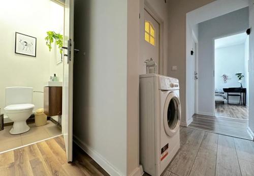 a bathroom with a washing machine in a room at Morska Aqua Massage Room 1 in Gdynia