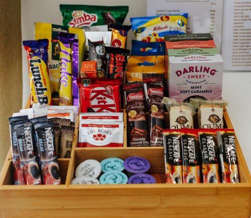 a shelf filled with different types of food and snacks at Fleur du Soleil Luxury Guesthouse in Franschhoek