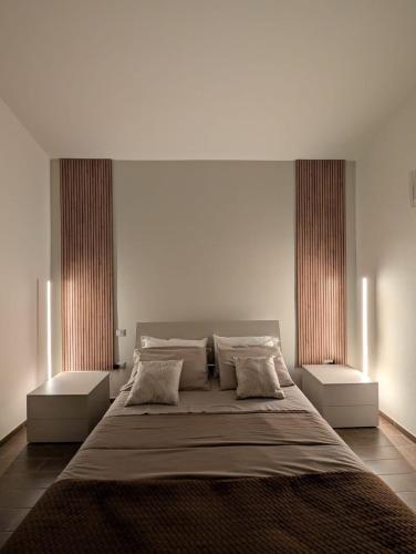 a bedroom with a large bed with two windows at Casa Tartaruga in SantʼAntìoco