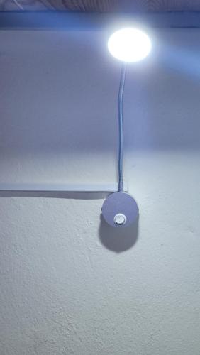 a lamp on a ceiling with a light on it at Meeting Point Praia-QC Beachwalk, also in Tarrafal & Fogo-NO CASH ACCEPTED in Praia