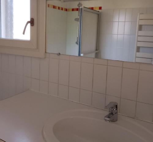 une salle de bain avec un lavabo et un miroir dans l'établissement Charmante Chambre 