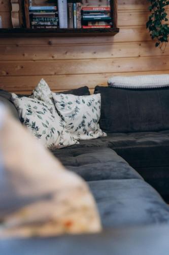 a couch with a pillow on it in a room at Szychów z widokiem in Stara Łomnica
