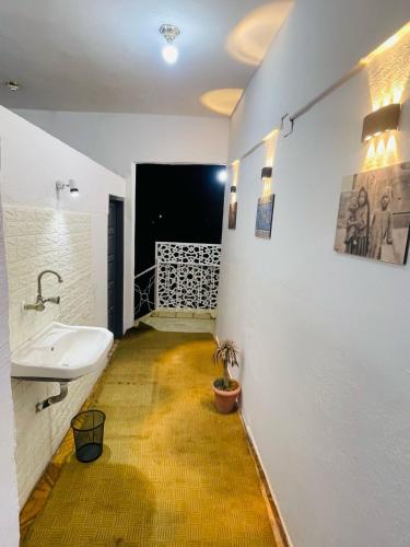 a bathroom with a white sink and a yellow floor at Toutankhamon in Luxor
