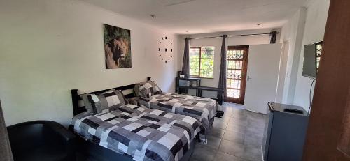 a bedroom with two beds and a window at Jukskei Big5 - Lion in Fourways