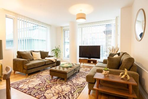 a living room with two couches and a tv at Northern Quarter Luxury 2 Bed Apt with balcony in Manchester