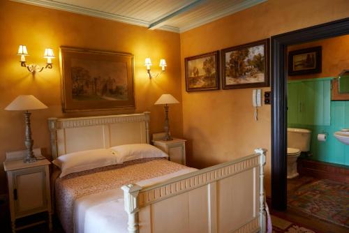 a bedroom with a bed and a bathroom at TwoAngels in Knysna