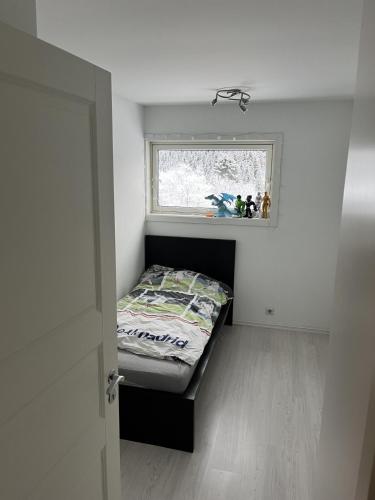 a small bedroom with a bed and a window at Trondheim in Trondheim
