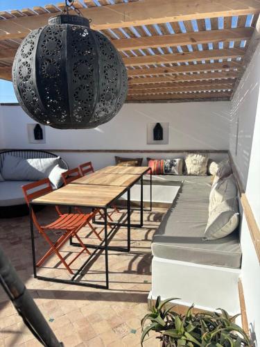 a patio with a table and a table and chairs at Riad Dar Dayana in Essaouira
