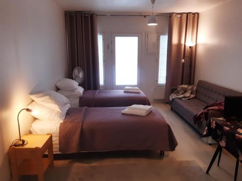 a living room with a bed and a couch at Kauppala, Soini kk in Soini