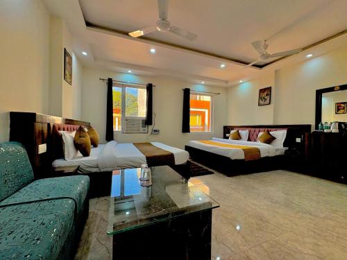a living room with two beds and a couch at Hotel Royal Central Haridwar in Haridwār