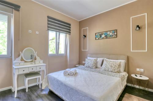 a bedroom with a bed and a vanity and a mirror at Casa Lorela in Sali