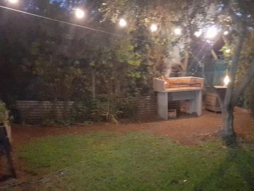 a piano sitting in a yard at night at El Naranjo in Chascomús