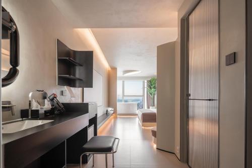 a kitchen with a black counter and a sink at Ziggy Hotel in Changsha