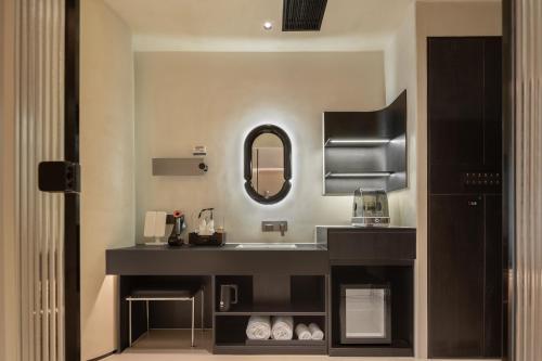 a bathroom with a sink and a mirror at Ziggy Hotel in Changsha