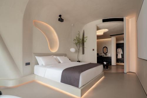 a bedroom with a white bed with lights on it at Ziggy Hotel in Changsha