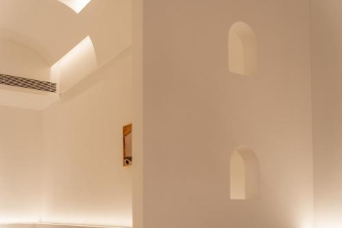 a room with white walls and arched ceilings at Ziggy Hotel in Changsha