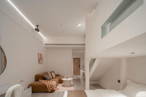 a living room with a couch and a table at Ziggy Hotel in Changsha