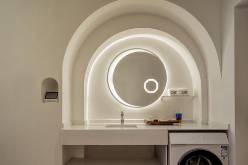 a bathroom with a sink and a mirror at Ziggy Hotel in Changsha