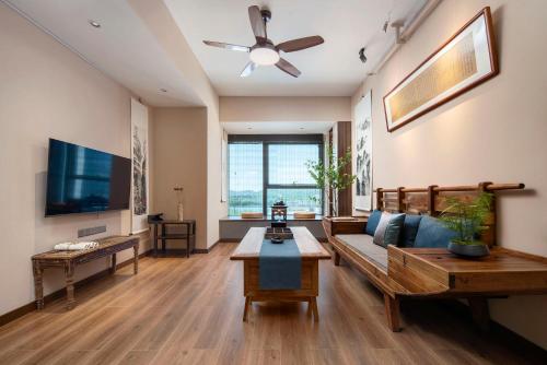 a living room with a couch and a flat screen tv at Ziggy Hotel in Changsha