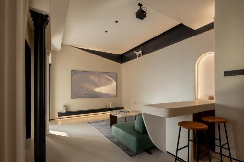 a room with a sink and a table and chairs at Ziggy Hotel in Changsha