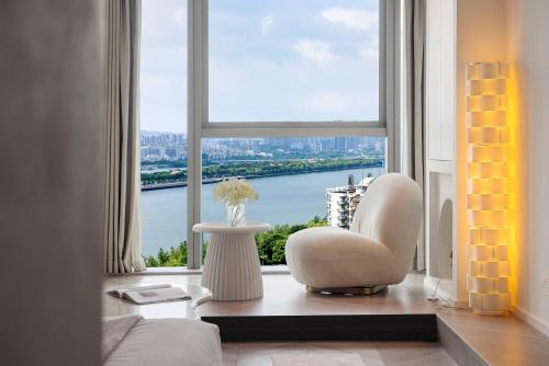 a living room with a large window with a view at Ziggy Hotel in Changsha
