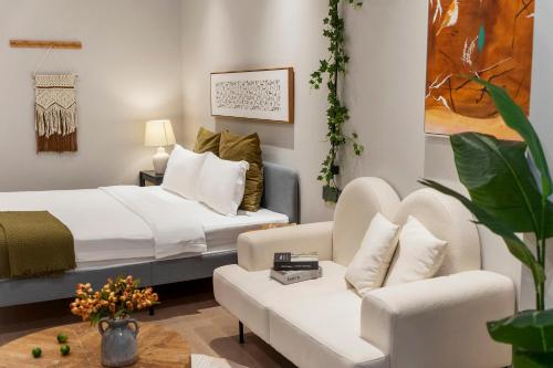 a hotel room with a bed and a couch at Ziggy Hotel in Changsha