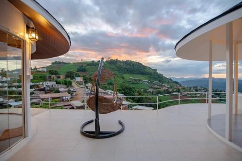 a balcony with a view of a city at Mon Sai Lom ม่อนสายลม ม่อนแจ่ม in Mon Jam