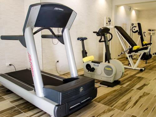 a gym with several exercise bikes and a treadmill at Terrado Suites Iquique in Iquique