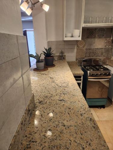 a kitchen with a granite counter top and a stove at Mila's House in La Romana