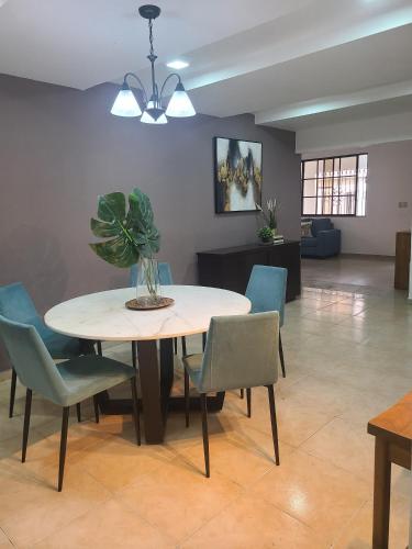un tavolo da pranzo con sedie e una pianta sopra di Mila's House a La Romana