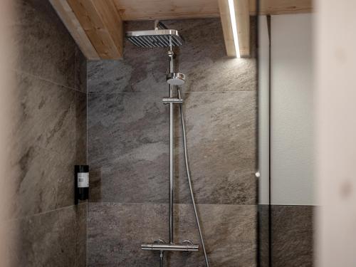 a shower in a bathroom with a glass door at Selda Chalet in Sölden
