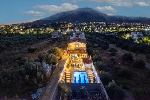 an aerial view of a house with a swimming pool at Villa Vegera in Anavissos