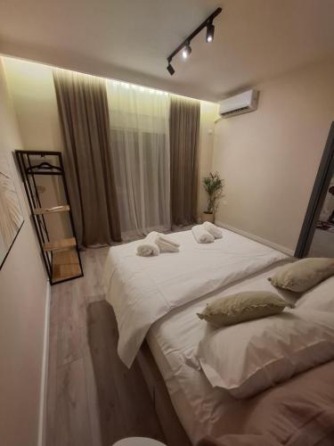 a bedroom with two beds and a mirror in it at CastleView Suites in Shkodër