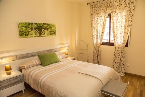 a bedroom with a large bed and a window at Jardines del Litoral Momas Homes in Málaga