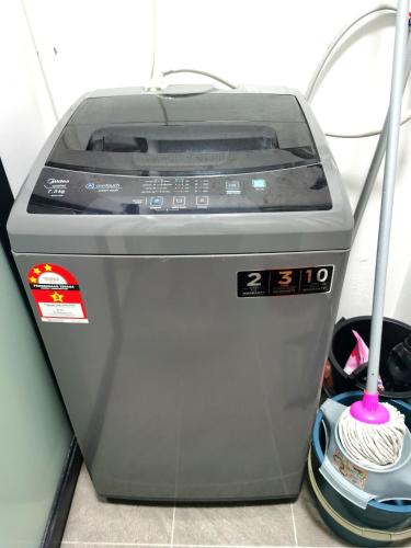 a machine with a mop on top of it at MJ Homestay 99 Batu Caves KL North 99Residence 3R2B in Kuala Lumpur