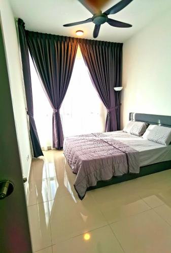 a bedroom with a bed with a ceiling fan at MJ Homestay 99 Batu Caves KL North 99Residence 3R2B in Kuala Lumpur