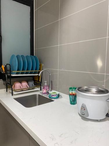 a bathroom counter with a sink and a mirror at MJ Homestay 99 Batu Caves KL North 99Residence 3R2B in Kuala Lumpur