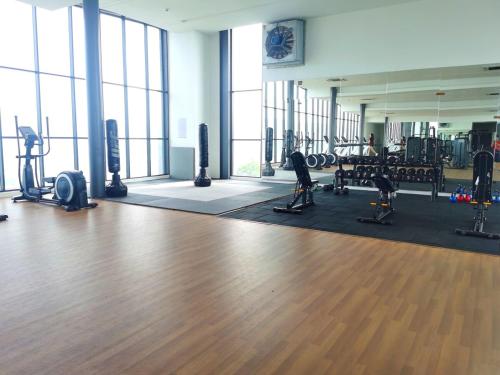 a gym with exercise equipment and a wooden floor at MJ Homestay 99 Batu Caves KL North 99Residence 3R2B in Kuala Lumpur