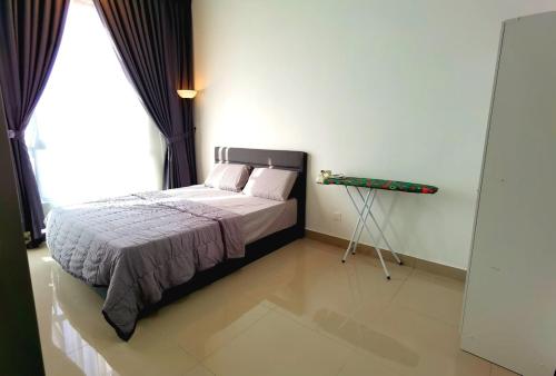 a bedroom with a bed with a tripod next to a window at MJ Homestay 99 Batu Caves KL North 99Residence 3R2B in Kuala Lumpur