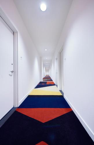 a hallway with a colorful rug on the floor at The Durham Hotel in Durham