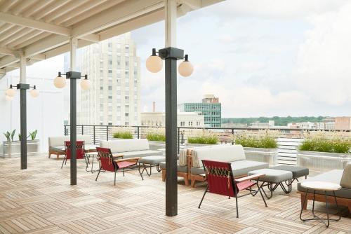 a patio with chairs and tables on a roof at The Durham Hotel in Durham