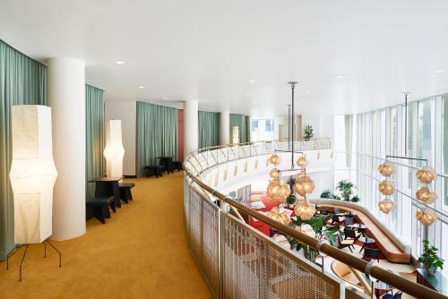 a large lobby with a long staircase with tables and chairs at The Durham Hotel in Durham