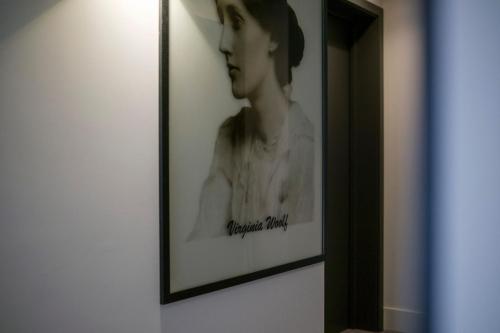 a black and white picture of a woman on a wall at Azores Book Hotel in Angra do Heroísmo