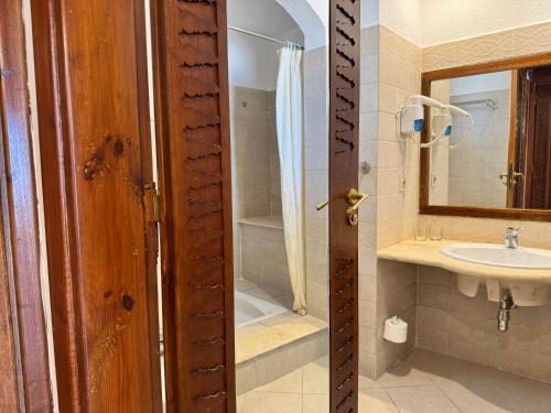 Sultan Sunscape - Premium Sea View Apartment at Domina Coral Bay في شرم الشيخ: حمام مع حوض ودش ومرآة