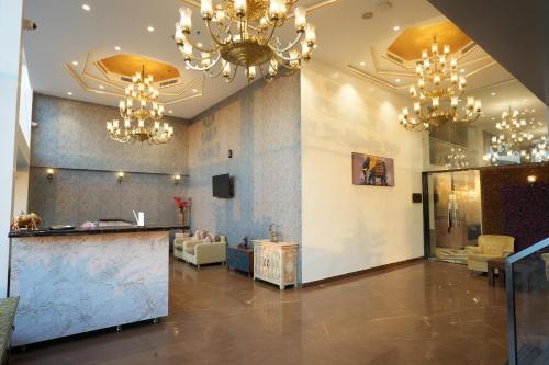 a lobby with chandeliers and a counter in a room at Stamps by Eight Continents, Jodhpur in Jodhpur