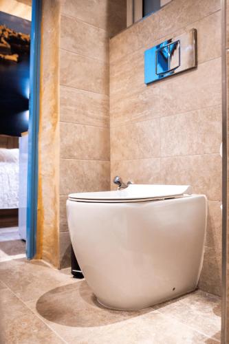 a bathroom with a toilet in a room at Valletta City Suites in Valletta