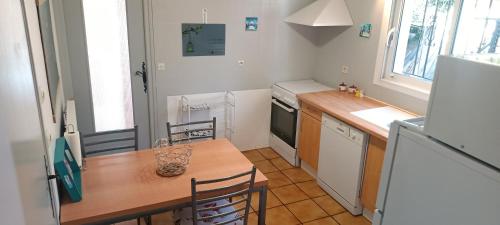 - une petite cuisine avec une table en bois et un comptoir dans l'établissement Gite individuel au pays BASQUE à 1,5km de ST-Jean-Pied-de-port, à Saint-Jean-Pied-de-Port